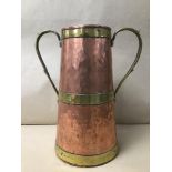 AN ARTS AND CRAFTS BRASS AND COPPER TWO HANDLE PAIL 28CMS