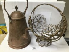 A COPPER COFFEE POT WITH A BRASS WIRE BASKET