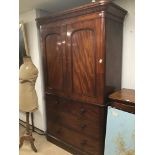 A LARGE 19TH CENTURY FLAME MAHOGANY LINEN PRESS WITH FOUR BOTTOM DRAWERS