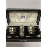 A THREE PIECE SILVER CONDIMENT SET WITH MATCHING SPOONS, IN ORIGINAL BOX, HALLMARKED LONDON 1931