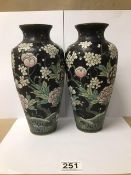 A PAIR OF JAPANESE CLOISONNE ENAMEL VASES, FLORAL SCENES ON A BLACK GROUND, 24CM HIGH (ONE A/F)