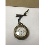 A CONTINENTAL SILVER LADIES FOB WATCH WITH HIGHLY ENGRAVED DECORATION THROUGHOUT, THE ENAMEL DIAL