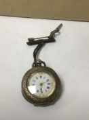 A CONTINENTAL SILVER LADIES FOB WATCH WITH HIGHLY ENGRAVED DECORATION THROUGHOUT, THE ENAMEL DIAL