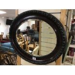 A VINTAGE BEVELLED EDGE MIRROR OVAL SHAPED 64 X 53CMS