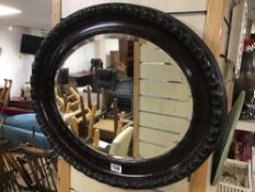 A VINTAGE BEVELLED EDGE MIRROR OVAL SHAPED 64 X 53CMS