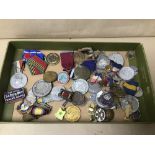A COLLECTION OF ASSORTED MILITARY MEDALS AND BADGES, SOME WITH RIBBONS