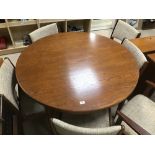 A MID CENTURY ROUND EXTENDING DINING TABLEWITH SIX RETRO CHAIRS
