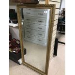 A BEVELLED EDGE GILDED FRAMED MIRROR 63 X 127 CM