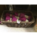 A BASKET WITH BUNDLES OF PINK RAFFIA