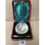 AN EDWARDIAN SILVER BUTTER DISH OF SHELL FORM, WITH MATCHING BUTTER SPOON, HALLMARKED SHEFFIELD 1905