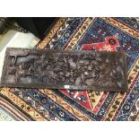 A HARDWOOD CARVED WALL PLAQUE WITH FIGHTING SCENES 99 X 33 CM