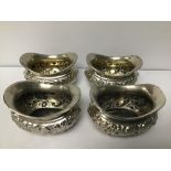 A SET OF FOUR EDWARDIAN SILVER EMBOSSED OVAL SALTS, HALLMARKED BIRMINGHAM 1908 BY JOSEPH GLOSTER