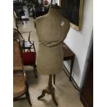 A VINTAGE MANNEQUIN ON WOODEN BASE