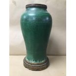 AN UNUSUAL ORIENTAL GREEN GLAZED VASE ADAPTED INTO A TABLE LAMP, RAISED UPON METAL BASE, 42CM HIGH