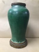 AN UNUSUAL ORIENTAL GREEN GLAZED VASE ADAPTED INTO A TABLE LAMP, RAISED UPON METAL BASE, 42CM HIGH