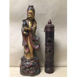 AN ORIENTAL CARVED WOODEN FIGURE OF A FEMALE CARRYING A WATER JUG, DECORATED WITH GILT AND RED,