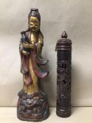 AN ORIENTAL CARVED WOODEN FIGURE OF A FEMALE CARRYING A WATER JUG, DECORATED WITH GILT AND RED,