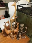 A COLLECTION OF WOODEN GIRAFFES AND ELEPHANTS LARGEST 60 CM