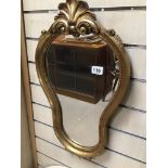 A HEAVY GILDED WALL MIRROR 66 X 37CMS