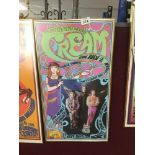 A FRAMED AND GLAZED "CREAM" POSTER 60 X 33CM