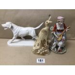 THREE ITEMS INCLUDING A PORCELAIN FIGURE, A CARVED HORN BIRD, AND A RESIN DOG