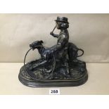 A BRONZE FIGURE GROUP OF A BOY WITH STICK BY A SNARLING GREYHOUND, HOLDING A HOOP, INDISTINCTLY