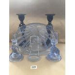 FIVE PIECES OF GLASSWARE INCLUDING A BLUE DRESSING TABLE SET AND TWO CANDLESTICKS
