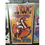 A FRAMED AND GLAZED NEIL YOUNG POSTER 63 X 33CM