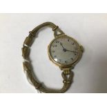 AN EARLY LADIES 18CT GOLD CASED WRISTWATCH, THE SILVERED DIAL WITH ARABIC NUMERALS DENOTING HOURS