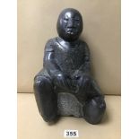 A LARGE HEAVY CARVED GRANITE FIGURE OF A STYLISED SITTING FIGURE, FROM ZIMBABWE SHOLA 31CM HIGH