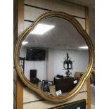 A VINTAGE ORIENTAL STYLE MIRROR IN A GILDED FRAME 61 X 61 CM