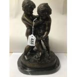 A BRONZE SCULPTURE OF TWO BOYS WRESTLING SIGNED GERIAFVICHI ON AN OVAL MARBLE BASE
