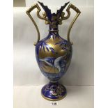 A LARGE VICTORIAN TWO HANDLED VASE DECORATED WITH BLUE AND WHITE SCENES OF STORKS EATING, BLUE AND