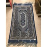 A BLUE VINTAGE RUG 70 X 132CMS