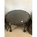 A VINTAGE MAHOGANY PIE CRUST ROUND TABLE ON BALL AND CLAW FEET