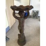 A CAST IRON BIRD BATH OF A BOY CARRYING A SHELL 87CM HIGH