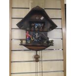 A VINTAGE CUCKOO CLOCK WITH ANIMATION FIGURES