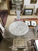 AN ORNATE PAINTED WROUGHT IRON GARDEN TABLE WITH FOUR FOLDING CHAIRS