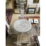 AN ORNATE PAINTED WROUGHT IRON GARDEN TABLE WITH FOUR FOLDING CHAIRS