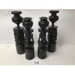 FOUR CANDLESTICKS MADE FROM AFRICAN WOOD CARVED WITH FIGURES 24.5CMS