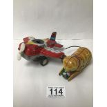 TWO TINPLATE TOYS A 1950S STARFIRE AEROPLANE MADE IN JAPAN AND A CAT MADE IN CHINA