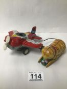TWO TINPLATE TOYS A 1950S STARFIRE AEROPLANE MADE IN JAPAN AND A CAT MADE IN CHINA