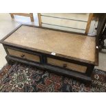 A TWO DRAWER LOW COFFEE TABLE DECORATED WITH CANE WEAVE