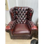 A THOMAS LLOYD OXBLOOD RED LEATHER CHESTERFIELD WING BACK ARMCHAIR