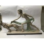 A LARGE ART DECO STYLE PLASTER FIGURAL GROUP DEPICTING A NUDE LADY PULLING BACK A DOG ON A LEAD,