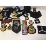 A COLLECTION OF MILITARY EMBROIDERED PATCHES