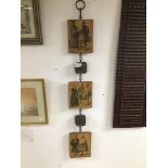 A VINTAGE CHAIN WITH PLAQUES WALL HANGING