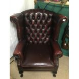 A THOMAS LLOYD OXBLOOD RED LEATHER CHESTERFIELD WINGBACK ARMCHAIR
