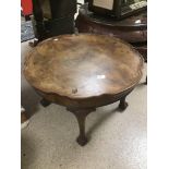 A VINTAGE WALNUT PIE CRUST TABLE ON BALL AND CLAW FEET