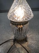 A CRYSTAL DROP SIDE LIGHT WITH ORNATE BRASS WORK